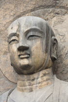 China, Henan Province, Luoyang, Carved Buddha statue in the Fengxian Temple, Tang Dynasty Longmen Grottoes and Cave.