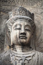 China, Henan Province, Luoyang, Carved Buddha statue in the Fengxian Temple, Tang Dynasty Longmen Grottoes and Cave.