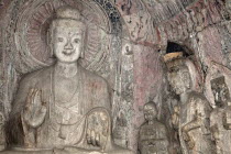 China, Henan Province, Luoyang, A carved stone Buddha, carved from the rock, Longmen Grottoes and Caves.