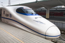 China, Shaanxi, Xian, Bullet train in railway station.