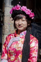 China, Yunnan Province, Lijiang, Mosuo girl wearing a colourful costume.