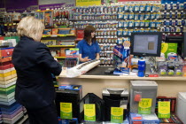 England, West Sussex, Chichester, Ryman's office staionery store with female shop assistant serving woman customer.