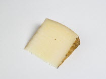 Food, Dairy Product, Cheeses, Slice of Spanish Manchego cheese made from pasteurised Manchega sheep's milk from the La Mancha region of Spain against a white background.