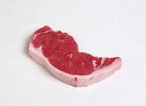 Food, Red Meat, Beef, Slice of raw uncooked sirloin steak on a white background.