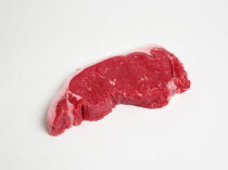 Food, Red Meat, Beef, Raw uncooked sirloin steak on a white background.