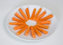 Food, Vegetable, Carrots, Slices of raw uncooked carrot on round white plate against a white background.