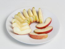 Food, Fruit, Apples, Slices of ripe apple on a white plate.