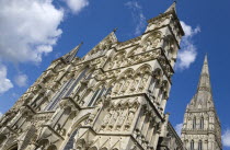 England, Wiltshire, Salisbury, The West Front main entrance of the 13th Century Early English Gothic Cathedral Church of the Blessed Virgin Mary with the tallest spire in Britain. The statues conform...