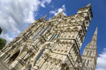 England, Wiltshire, Salisbury, The West Front main entrance of the 13th Century Early English Gothic Cathedral Church of the Blessed Virgin Mary with the tallest spire in Britain. The statues conform...