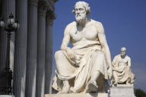 Austria, Vienna, Statue of the Greek philosopher Thucydides in front of the columns to the Parliament Building.