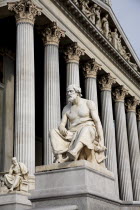 Austria, Vienna, Statue of the Greek philosopher Thucydides in front of the columns to the Parliament Building.