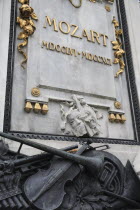 Austria, Vienna, Detail at the base of the statue of Mozart in the Burggarten.