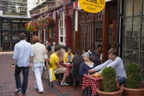 England, East Sussex, Brighton, The Lanes, people sat outside a Spanish Tapas restaurant.