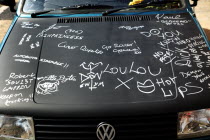 Ireland, North, Belfast, Graffiti on car bonnet.