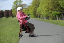 Society, People, elderly woman sat in mobility walking aid.