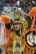 Canada, Alberta, Lethbridge, International Peace Pow Wow, Blackfeet Indian from Browning Montana USA in full costume with feather headress and bustle participating in dance competition.