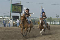 Canada, Alberta, Pincher Creek, Rodeo Queens and DRIVE SAFELY notice at the conclusion of the rodeo.