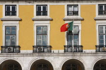 Portugal, Lisbon, Government building in Praca do Comercio with flag flying.