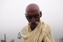 India, Uttarakhand, Hardiwar, Head and shoulders portrait of pilgrim beside the River Ganges during Kumbh Mela, Indias biggest religious festival where many different traditions of Hinduism come toget...