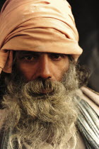 India, Uttarakhand, Hardiwar, Head and shoulders portrait of man with thick grey beard.
