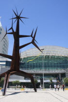 Portugal, Estremadura, Lisbon, Homem Sol sculpture by Jorge Vieira and the Vasco da Gama shopping centre in the Park of Nations.