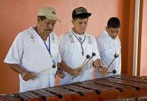 Honduras, Roatan Island, Mahogany Bay, Local musicans playing traditional music on the marimba.