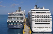 Mexico, Quintana Roo, Costa Maya, Dutch registered Holland America Line cruise ship Niew Amsterdam dwarfed by the Italian MSC cruise ship Poesia, passengers on pier.