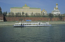 Russia, Moscow, Great Kremlin Palace with pleasure boat on the Moskva Mockba River. 