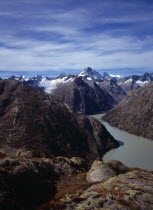 Switzerland, Bern, Grimselsee, Glacial lake viewed from the east above the Grimsel Pass. Peak of Finsteraarhorn partly covered in snow at centre on skyline 4274 metres.