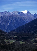 Switzerland, Ticino , Dotra, Scattered settlement of Dotra with snow glacier of Rheinwaldhorn mountain beyond 3402 metres.