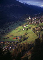 Switzerland, Valais, Ernen, Village of Ernen caught in brief moment of sunshine above the Rhone Valley.