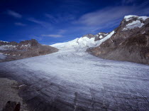 Switzerland, Valais, Rhone Glacier, Upper Rhone glacier from the Nagelisgratei Path with highpoint of Galenstock at 3586 metres. High windswept cloud in blue sky above.