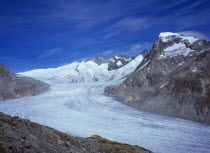Switzerland, Valais, Rhone Glacier, Upper Rhone glacier from the Nagelisgratei Path with highpoint of Galenstock at 3586 metres. High windswept cloud in blue sky above.