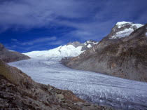 Switzerland, Valais, Rhone Glacier, Upper Rhone glacier from the Nagelisgratei Path with highpoint of Galenstock at 3586 metres. High windswept cloud in blue sky above.