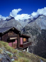 Switzerland, Zermatt, Mattertal, View towards west side of snow topped peak of Dom and Taschhorn mountains from Schaferhuttli chalet in foreground.