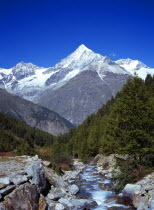 Switzerland, Zermatt, Weisshorn mountain 4506 metres seen from Ottavan with rocky Taschbach stream in foreground.