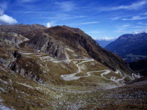 Switzerland, Ticino, The original cobble surface snaking mountain road from Airolo to St Gottard Pass viewed from the west.