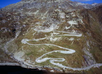 Switzerland, Ticino, The original cobble surface snaking mountain road from Airolo to St Gottard Pass viewed from the west.