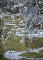 Switzerland, Ticino, The original cobble surface snaking mountain road from Airolo to St Gottard Pass viewed from the west.