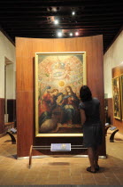 Mexico, Bajio, Zacatecas, Tourist looking at the Anuncion by Cristobel de Villalpondo in the Monastery Museum of Guadalupe.