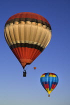 USA, New Mexico, Albuquerque, Annual balloon fiesta, Colourful hot air balloons in flight.