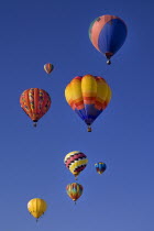 USA, New Mexico, Albuquerque, Annual balloon fiesta, Colourful hot air balloons in flight.