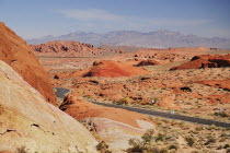 USA, Nevada, Valley of Fire State Park, with highway winding through rocky landscape.