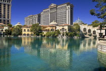 USA, Nevada, Las Vegas, The Strip, view across the pool outside the Bellagio toward Caesars Palace hotel and casino.