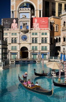 USA, Nevada, Las Vegas, The Strip, tourists in gondoal outside the entrance to the Venetian hotela dn casino.