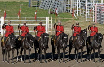Canada, Alberta, Lethbridge, Royal Canadian Mounted Police Musical Ride, RCMP cavalry in full dress red serge uniform on horseback holding lances with red and white pennons.