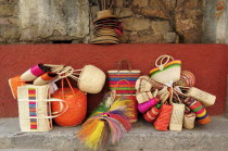 Mexico, The Bajio, San Miguel de Allende, Colourful straw baskets for sale in the market.