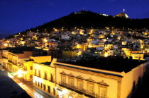 Mexico, Bajio, Zacatecas, Night view across city buildings looking towards Cerro de la Buffa.