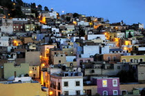 Mexico, Bajio, Zacatecas, Colourful housing across hillside at night.