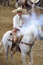 Mexico, Bajio, Zacatecas, Traditional horseman or Charro competing in Mexican rodeo, holding lasso.